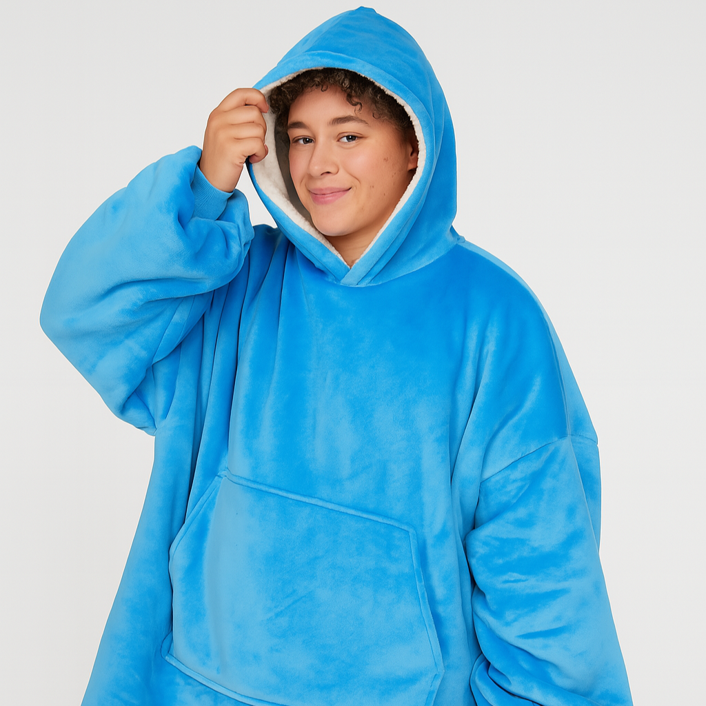 Person wearing a blue hooded poncho against a white background