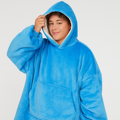Person wearing a blue hooded poncho against a white background